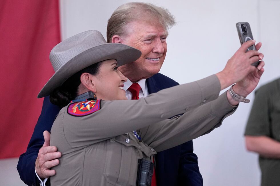 Republican presidential candidate and former President Donald Trump poses for a photo with a...
