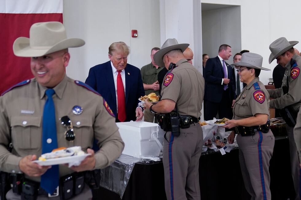Republican presidential candidate and former President Donald Trump helps serve food to Texas...