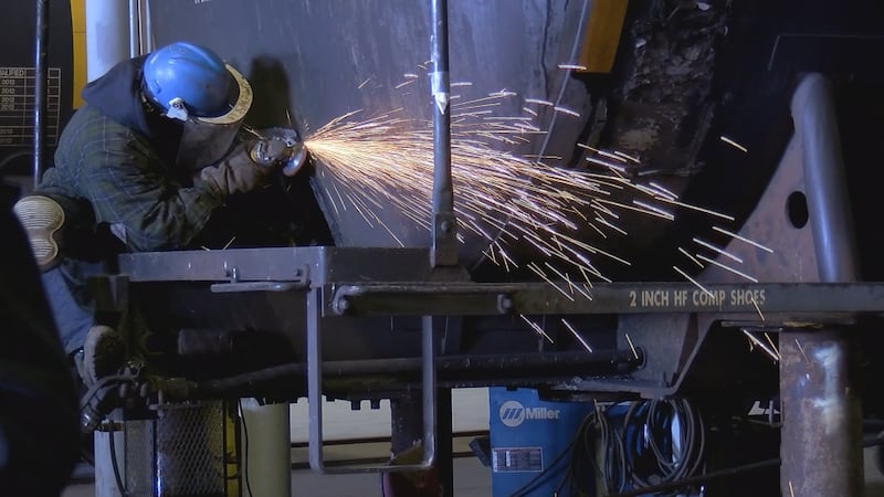 A worker works on one of the railcars at the plant.