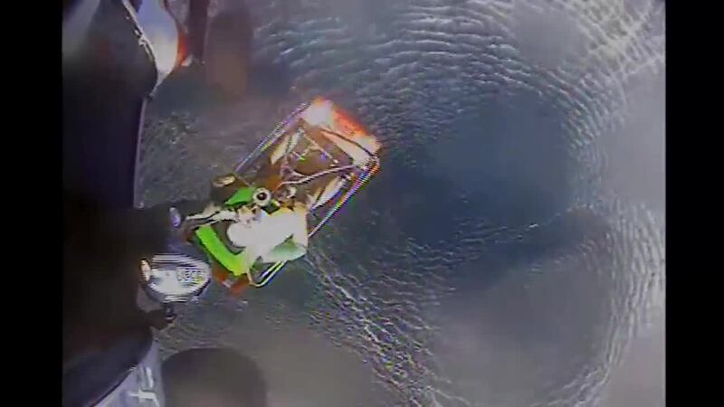 The Coast Guard rescued a couple and their dog from a stranded sailboat.