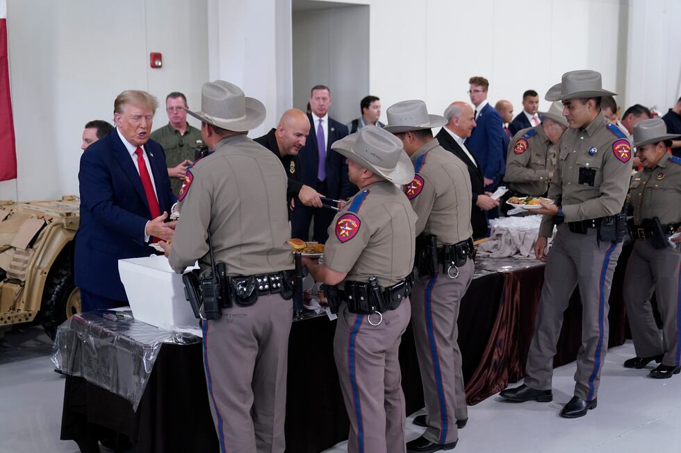 Republican presidential candidate and former President Donald Trump helps serve food to Texas...