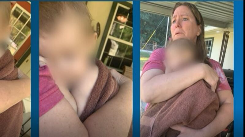 The child was wrapped in a towel while waiting an ambulance.