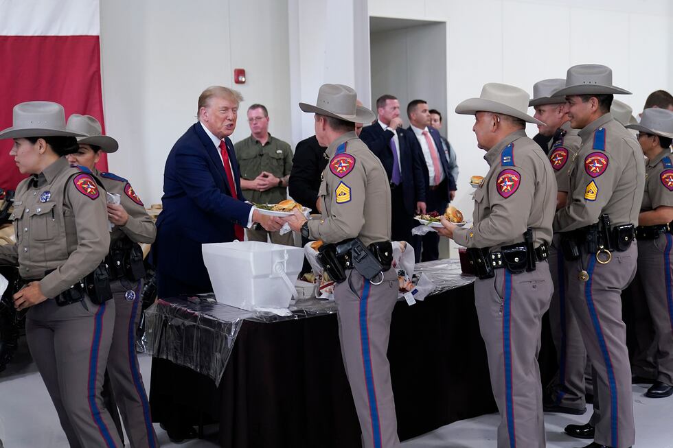 Republican presidential candidate and former President Donald Trump helps serve food to Texas...